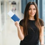 tourism-holiday-vacation-childhood-transportation-concept-smiling-little-girl-with-travel-bag-airport-background_255667-58877